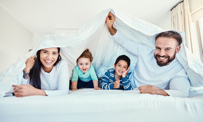 Poster - Family, portrait and blanket fort in bed with children and parents, happy and playing in their home. Face, under and sheet by kids with mom and dad in bedroom, fun and waking up, relax and smile