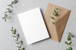 Invitation or save the date card mockup with envelope and fresh eucalyptus twigs