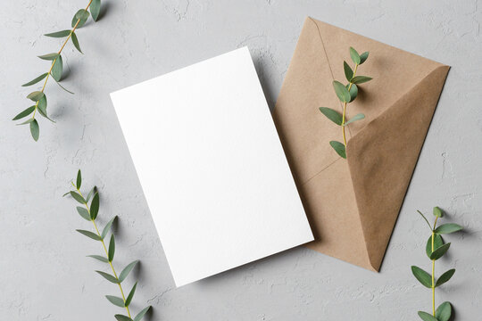 invitation or save the date card mockup with envelope and fresh eucalyptus twigs