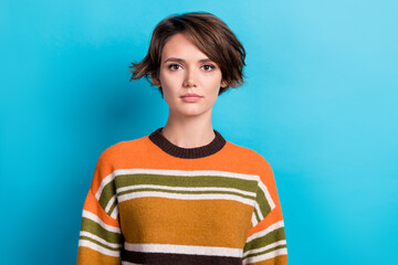 Poster - Photo of serious confident woman dressed striped pullover looking you isolated blue color background