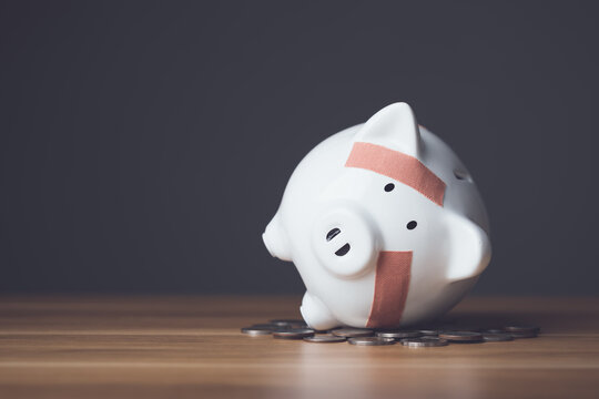 financial problem, bankrupt or fail in business concept. white piggy bank with plastic adhesive band