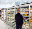© lado2016 - supermarket shopping,Woman choosing a dairy products at supermarket.