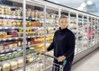© lado2016 - supermarket shopping,Woman choosing a dairy products at supermarket.