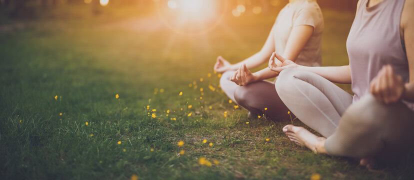 Fototapete - Two women sitting in active wear in lotus position in nature.