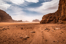 Clouds Of Sand Blow Around Rocks In The Midst Of A Vast Sand Desert In Wadi Rum Desert. Jordan