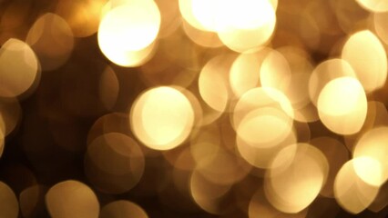 Wall Mural - Golden Bokeh In sepia Tones Abstract Movement Background. Sparkling magical particles. Abstract blurred light circles element. 
