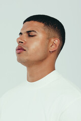 Wall Mural - Young man standing in a studio, showing his beautiful skin