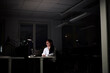 © Johnér - Woman working late in office