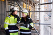 © Johnér - Engineers talking at building site
