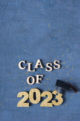 Wall Mural - Graduated 2023 concept. Class of 2023 text with graduate cap on dark background with bokeh