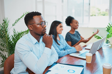 Wall Mural - Serious Black businessman concentrates during boardroom meeting in office