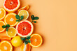 top view of orange grapefour and lemon citrus fruits with  herbs on yellow background