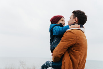 Wall Mural - Father and his cute son hugging during walk in nature