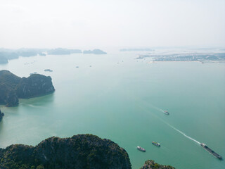 Aerial view floating fishing village and rock island, Ha Long Bay, Vietnam, Southeast Asia. UNESCO World Heritage Site. Junk boat cruise to Ha Long Bay