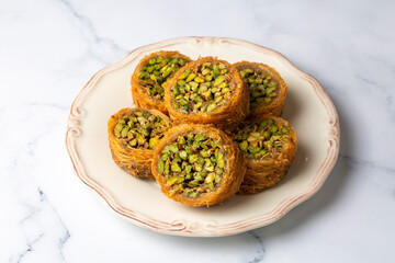 Wall Mural - Traditional Turkish desserts; Kadaif stuffed with pistachios. Turkish name; Kadayif dolmasi or dolma kadayif. Halep sarma, halep sarmasi.