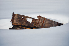 An Abandoned Horse-drawn Carriage In The Snow