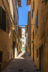 Wall Mural - Cortona, Italy. Narrow medieval street