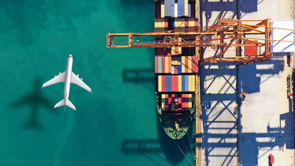 Aerial drone top down concept photo of container terminal and plane flying above indicating popular cargo means of transport