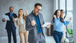 © Dragana Gordic - Shot of office staff celebrating a win. Success and team work concept. Group of business partners with raised up hands in light modern workstation, celebrating the breakthrough in their company