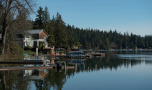 Lake houses along the shore of a clear lake landscape in Eatonville, Washington wilderness near Mount Rainier National Park 