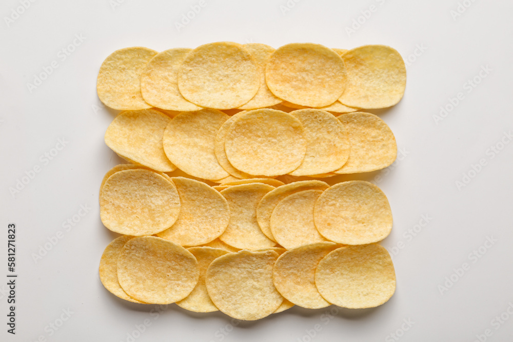 Delicious potato chips on white background