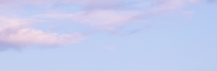 Wall Mural - blue sky background with white and pink clouds at sunset