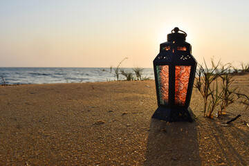 A beautiful sea side view with a lantern lamp, Nature background Ramadan and Eid concept Selective focus