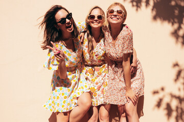 three young beautiful smiling hipster female in trendy summer dresses clothes. sexy carefree women p
