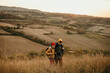 © La Famiglia - A mid adult father walking and talking with his teenage son in an autumn field, exploring and having fun.