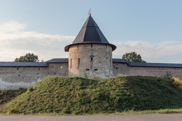 View of the wall and towers of The Holy Dormition Pskovo-Pechersky Monastery. Russia.