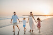 © Halfpoint - Happy family with little kids enjoying time at sea in exotic country.