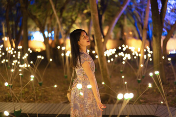 Portrait of happy Asian woman with bokeh blurry background for lighting festive celebration concept. illumination. People lifestyle.