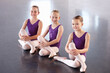 © Anton Robert/peopleimages.com - Ballerinas in the making. Happy young ballerinas sitting in a ballet studio.
