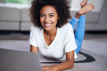 Canvas Print - You should read my blog sometime. Portrait of a young woman lying on the floor with her laptop.