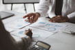 © kamiphotos - Company meeting room has businessmen and finance managers meeting together on finance topics, they are looking at information on documents and discussing together. Concept company financial management