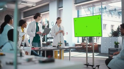 Aufkleber - Excited Young Female Specialist Doing a Presentation, Using Green Screen Monitor and Talking to her Colleagues in a Laboratory. Team of Engineers Having a Meeting, Brainstorming While Using Technology