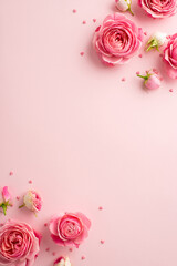 Wall Mural - 8-march concept. Top view vertical photo of fresh peony roses and sprinkles on isolated pastel pink background with copyspace