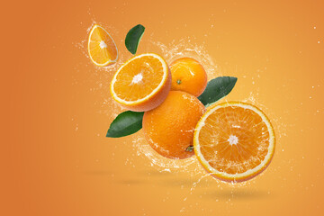 Wall Mural - Water splashing on Fresh Sliced ​​oranges and Orange fruit on Orange background