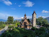 Fototapeta  - Old wooden Vang stave church with stone tower in summer. Karkonosze mountains, Karpacz, Poland