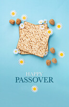 Passover Greeting Card With Matzah, Nuts Daisy And Tulip Flowers On Blue Background.