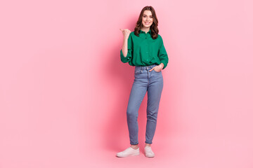 Sticker - Full length photo of funny cute lady dressed green blouse pointing thumb emtpy space isolated pink color background