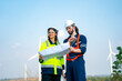 © FotoArtist - Wind turbine service engineer maintenance and plan for inspection at construction site, renewable electricity generator.