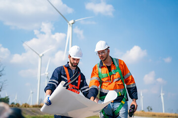 Wind turbine service engineer maintenance and plan for inspection at construction site, renewable electricity generator.