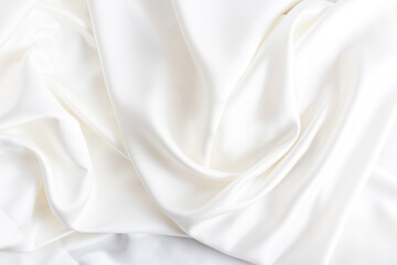 luxury wedding textiles. satin beige delicate background. soft waves of satin fabric.