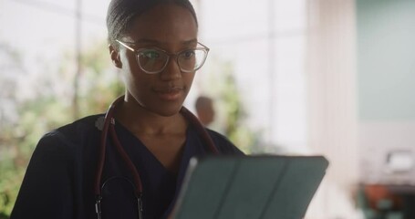 Wall Mural - Portrait of a Black Female Medical Health Care Professional Working on Tablet Computer in Hospital Office. Clinic Head Nurse is Appointing Prescriptions Online, Updating Electronic Health Records