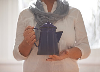 Poster - Care for some tea. Cropped view of a woman holding a teapot in her hands.