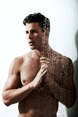 Wall Mural - Showering helps him think more clearly. a handsome man taking a shower.