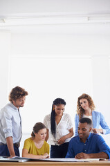 Poster - Young and creative minds hard at work. A group of young coworkers discussing work.