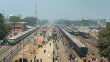 Timelapse View Of Passengers Boarding And Climbing Onto The Roof Of Trains At Railway Station In The Suburbs Of Dhaka, The Capital Of Bangladesh And One Of The World's Most Densely Populated Cities.