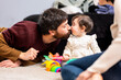© ADDICTIVE STOCK - Happy father kissing little baby girl at home